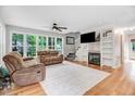 Cozy living room features a fireplace, built-in shelving, and plush seating for relaxing at 132 Ironwood Ln, Clayton, NC 27520