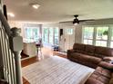 Inviting living room featuring hardwood floors, natural light, and an open floorplan to the kitchen at 132 Ironwood Ln, Clayton, NC 27520