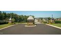 Grand Highland Estates entrance with black iron gates, stone accents, and well-maintained landscaping at 1725 Legacy Ridge Ln, Wake Forest, NC 27587