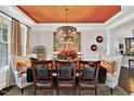 Formal dining room features unique lighting, decor and seating at 1806 Pattersons Mill Rd, Durham, NC 27703