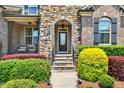 Inviting front entrance with stone steps and colorful landscaping at 1806 Pattersons Mill Rd, Durham, NC 27703