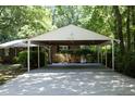 Spacious covered carport attached to a brick home, offering ample parking and protection from the elements at 1964 Wellington Rd, Burlington, NC 27217
