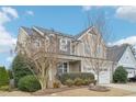 Beautiful home with manicured landscaping, mature trees, and a welcoming facade at 1985 Firenza Dr, Apex, NC 27502