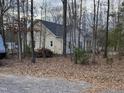 Secluded view of home in the woods with gravel driveway at 206 E Silver Belle Dr, Zebulon, NC 27597