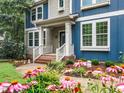 Charming front porch with decorative plants and flowers adding curb appeal at 218 Inwood Forest Dr, Raleigh, NC 27603