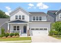 Charming two-story home boasts a manicured lawn and attached garage with a traditional architectural style at 223 Chauncey Cir, Chapel Hill, NC 27516