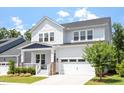 Charming two-story home boasts a manicured lawn and attached garage with a traditional architectural style at 223 Chauncey Cir, Chapel Hill, NC 27516