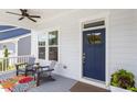 Inviting front porch with seating area, colorful rug, and tasteful decor creates a warm welcome at 223 Chauncey Cir, Chapel Hill, NC 27516