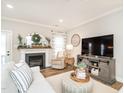 Cozy living room with fireplace, neutral decor, and plenty of natural light at 2413 Whelen Dr, Graham, NC 27253