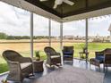 Relaxing screened patio with comfortable seating and views of the expansive backyard at 2413 Whelen Dr, Graham, NC 27253