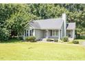 Inviting one-story home with green lawn, a chimney, and manicured landscaping at 2474 Sumter Dr, Garner, NC 27529