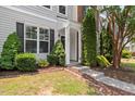 View of the front of the home with lush landscaping and a well-manicured lawn at 3100 Berkeley Springs Pl, Raleigh, NC 27616