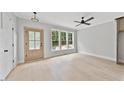 Bright bedroom with light wood floors, neutral paint, and a modern ceiling fan at 317 W Murray Ave, Durham, NC 27704
