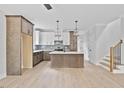 Modern kitchen featuring a center island, stylish pendant lighting, and stainless steel appliances at 317 W Murray Ave, Durham, NC 27704