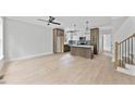 Spacious living room with an open floor plan, light wood floors, and modern kitchen view at 317 W Murray Ave, Durham, NC 27704