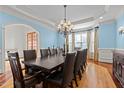 Formal dining room with a large table, chandelier, and elegant blue walls at 3311 Canoe Brook Pkwy, Raleigh, NC 27614