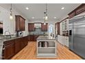 Spacious kitchen boasts hardwood floors, a center island, and stainless steel appliances at 3311 Canoe Brook Pkwy, Raleigh, NC 27614