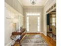 Elegant foyer featuring hardwood floors, decorative console table, and a paneled wall at 334 Dell Meadows Pl, Four Oaks, NC 27524