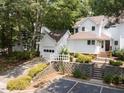 Charming two-story home with landscaped front yard and detached garage at 3811 Carnegie Ln, Raleigh, NC 27612