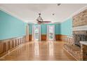 Spacious living room features a brick fireplace, hardwood floors, and natural light at 3821 Whispering Branch Rd, Raleigh, NC 27613