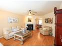 Cozy living room with hardwood floors, fireplace, and ample seating, ideal for relaxation at 412 Onondaga Ct, Holly Springs, NC 27540