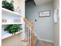 Bright staircase with decor, leading to the upper level at 412 Onondaga Ct, Holly Springs, NC 27540