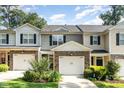 Charming townhome featuring a two-car garage, stone accents, and lovely landscaping at 4732 Altha St, Raleigh, NC 27606