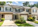 Inviting townhome featuring a two-car garage, stone accents, and manicured landscaping at 4732 Altha St, Raleigh, NC 27606