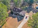 Lush aerial view showcases the charming home with firepit, long driveway, and picturesque surroundings at 506 Tirzah Dr, Lillington, NC 27546