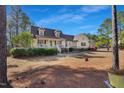 Inviting two-story home with dormers, front porch with white railings, and well-manicured lawn at 506 Tirzah Dr, Lillington, NC 27546