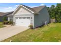 Two-car garage with a white door, side yard, and well-maintained exterior at 515 Legacy Dr, Youngsville, NC 27596