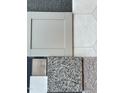 A neutral color palette of material samples for cabinet doors, flooring, tile, and carpet at 521 Olivia Crossing Ct # 19, Four Oaks, NC 27524