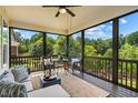 Inviting screened porch with comfortable seating and a view of lush green trees at 610 Bennett Mountain, Chapel Hill, NC 27516