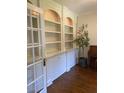 Elegant built-in shelving with classic white cabinetry and hardwood floors at 8512 Barrett Hall Ln, Wake Forest, NC 27587