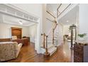 Bright foyer with staircase and hardwood floors throughout at 8512 Barrett Hall Ln, Wake Forest, NC 27587