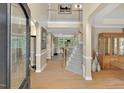 Elegant foyer with hardwood floors, staircase, and soaring ceilings creating an inviting entrance at 9 Monteith Ct, Durham, NC 27713