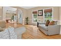 Bright living area with hardwood floors, neutral paint, and large windows at 9 Monteith Ct, Durham, NC 27713
