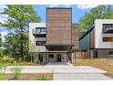 Modern home with striking wood accents, covered parking, and a meticulously designed landscape at 922 Tower St, Raleigh, NC 27607