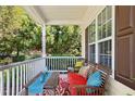 Relaxing front porch with comfortable seating, featuring a decorative rug and a view of the lush greenery at 9416 Buggy Run Cir, Wake Forest, NC 27587