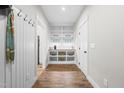 Walk-in pantry with built-in shelving, decorative accents, a beverage center and hardwood flooring at 1004 Snow Peak Ct, Raleigh, NC 27603