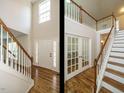 Elegant foyer featuring hardwood floors, a staircase, and an abundance of natural light at 1035 Evening Shade Ave, Rolesville, NC 27571