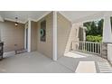 Inviting covered porch with craftsman details, decorative wreath, and ample space for seating at 1123 Ambrose Dr, Rolesville, NC 27571