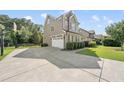 Spacious driveway leading to a two-car garage, with basketball hoop and well-maintained landscaping at 1123 Ambrose Dr, Rolesville, NC 27571