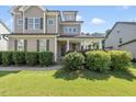 Inviting two-story home with covered porch, well-kept landscaping and dark trim at 1123 Ambrose Dr, Rolesville, NC 27571