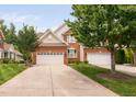 Inviting brick home with a well-manicured lawn, showcasing the attached two-car garage at 11571 Auldbury Way, Raleigh, NC 27617