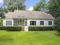 Spacious backyard features a screened porch with a small stairway and manicured shrubs at 150 Williamston Ridge Dr, Youngsville, NC 27596