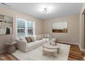 Inviting living room with a comfortable white sofa, stylish decor, and lots of natural light at 1611 Poole Rd, Raleigh, NC 27610