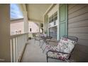 Inviting front porch features comfortable seating and charming details, creating a cozy outdoor space at 1909 Piperwood Ct, Durham, NC 27713