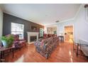 Inviting living room with a fireplace, comfortable seating, and hardwood floors for a warm and cozy atmosphere at 1909 Piperwood Ct, Durham, NC 27713