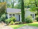 Quaint home featuring lush landscaping, a concrete patio, and peaceful setting at 2849 Rue Sans Famille, Raleigh, NC 27607